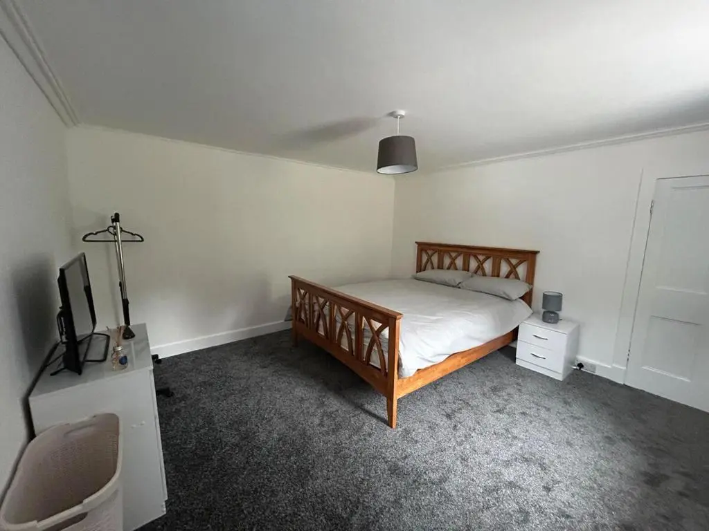 a bedroom with a bed and a tv in it at Burnside Cottage in Fochabers