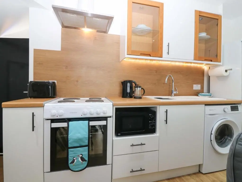 a kitchen with a stove and a sink at 3 Caroline Place in Fraserburgh