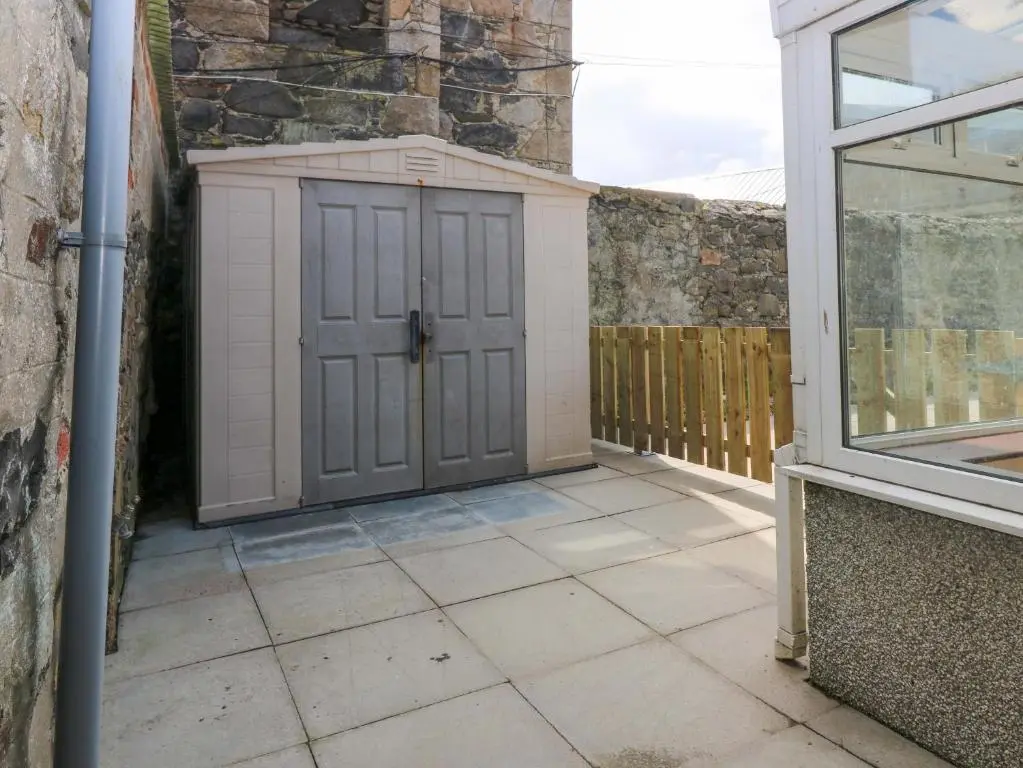 a door on the side of a house with a window at 3 Caroline Place in Fraserburgh