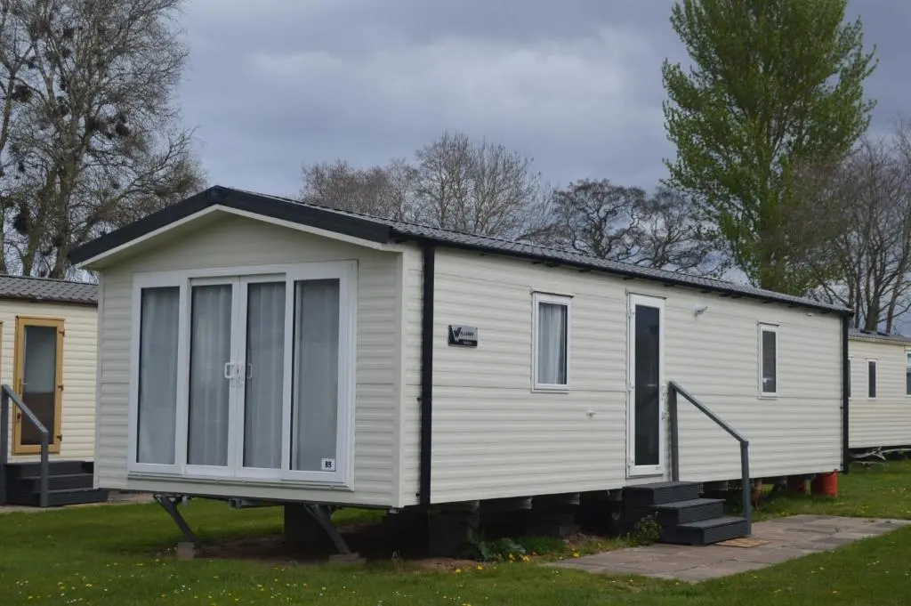 a tiny house on a stand in a yard at B9 at The Old Mill Holiday Park in Dyke