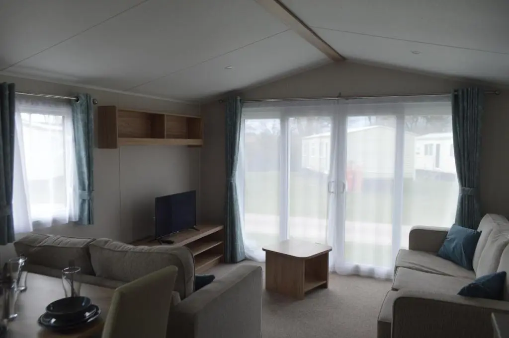a living room with a couch and a tv at B9 at The Old Mill Holiday Park in Dyke