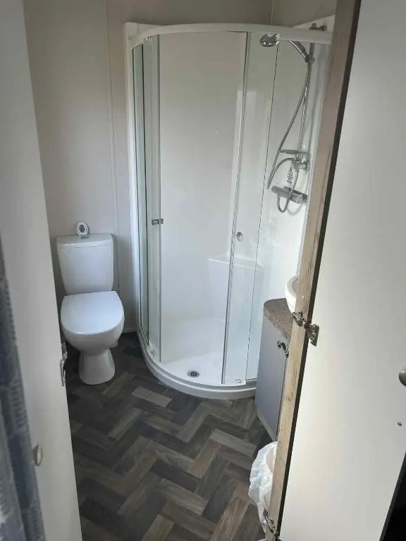 a bathroom with a shower and a toilet at Clearwater Lodge in Lossiemouth