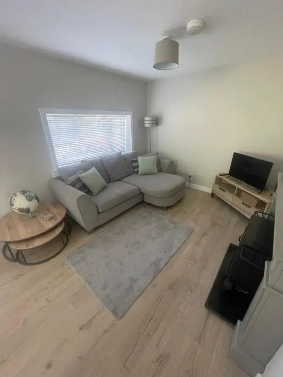a living room with a couch and a table at 51 Island Bank in Inverness