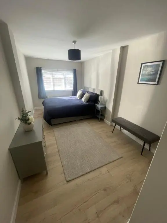 a bedroom with a bed and a table and a window at 51 Island Bank in Inverness
