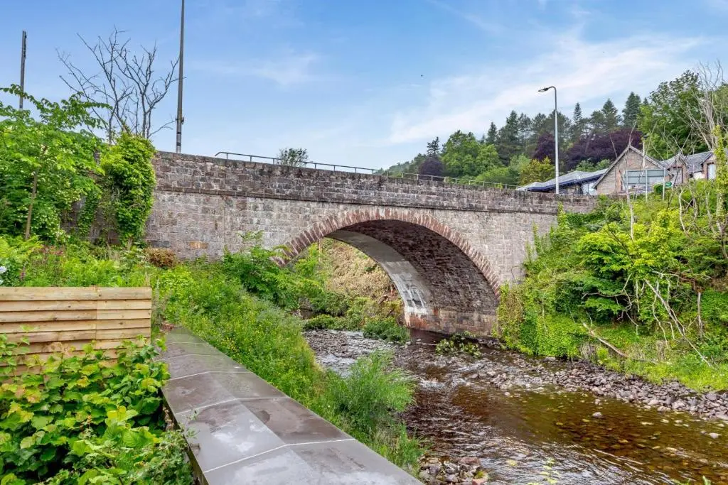 a stone bridge over a stream with a river at 1 Bed in Drumnadrochit oc-t32404 in Drumnadrochit
