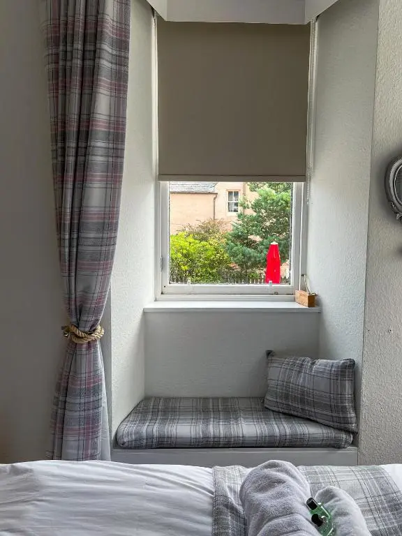 a window seat next to a bed in a bedroom at Crown and Anchor Inn in Findhorn