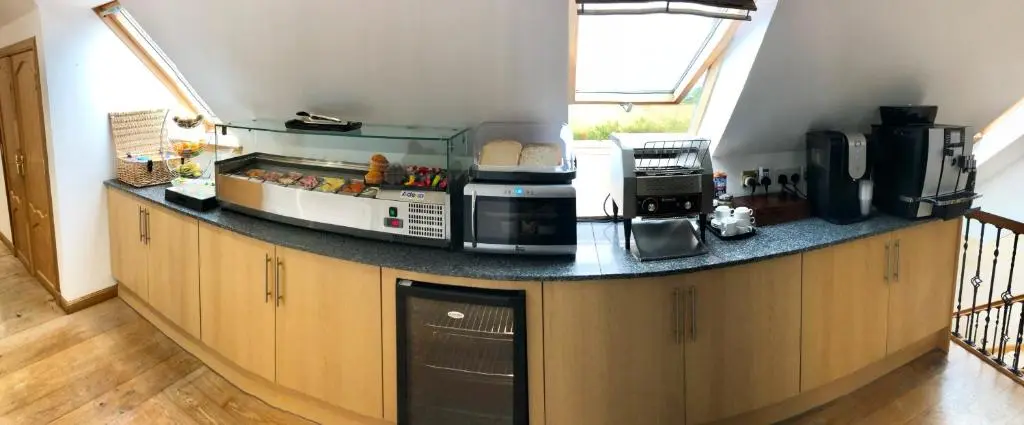 a kitchen with a counter top with a microwave at Druid House B&B in Inverness