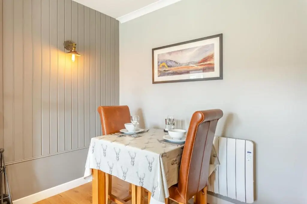 a dining room with a table and chairs at 1 Bed in Newtonmore oc-a32412 in Newtonmore