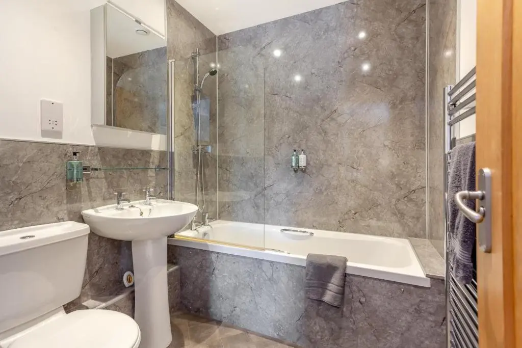 a bathroom with a sink and a tub and a toilet at 1 Bed in Newtonmore oc-a32412 in Newtonmore