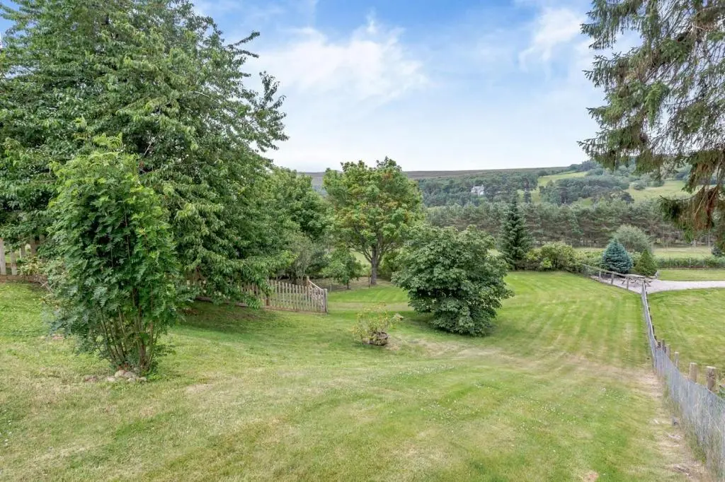 an image of a yard with trees and a fence at 1 Bed in Newtonmore oc-a32412 in Newtonmore