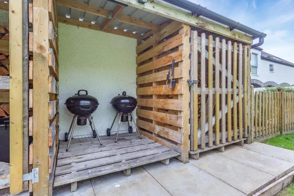 a pergola with two bbqs on a patio at 3 Bed in Newtonmore oc-h32416 in Newtonmore