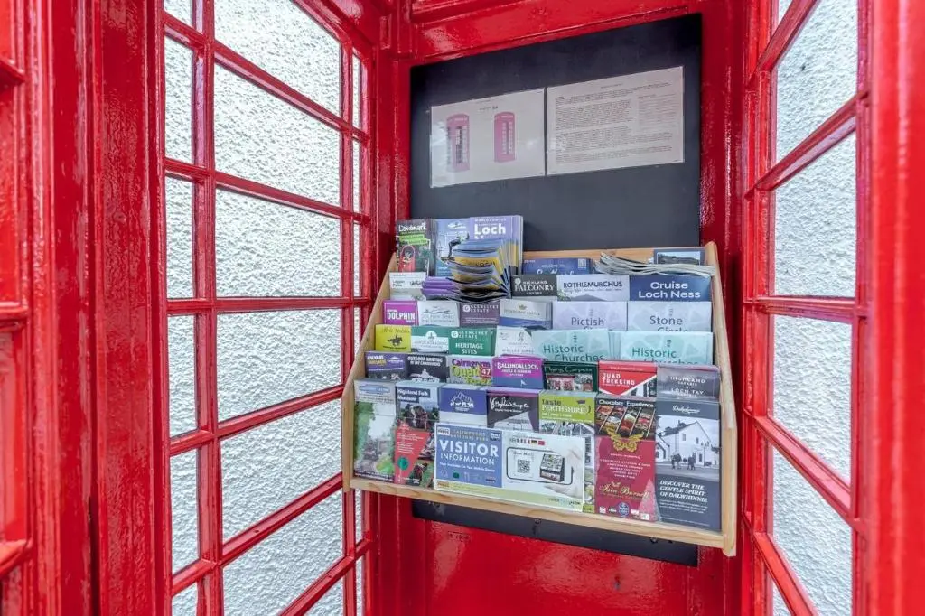 a red phone booth with a bunch of books at 3 Bed in Newtonmore oc-h32416 in Newtonmore