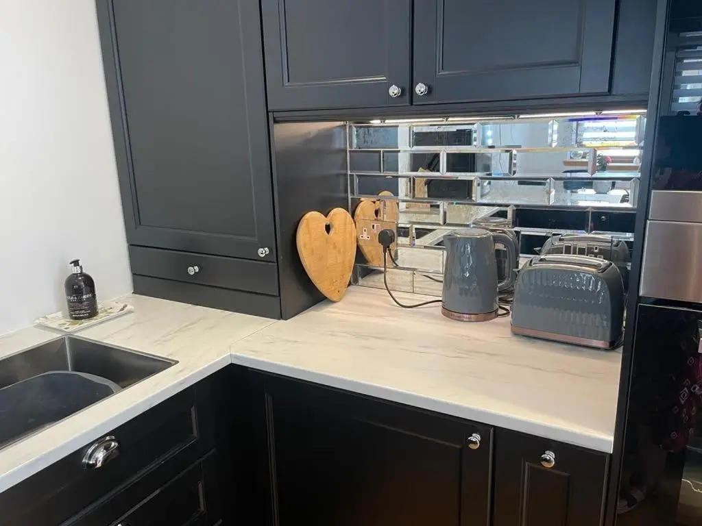 a kitchen with a counter top with a toaster and a toaster at 2 Bed House - free parking, short walk to City centre in Inverness