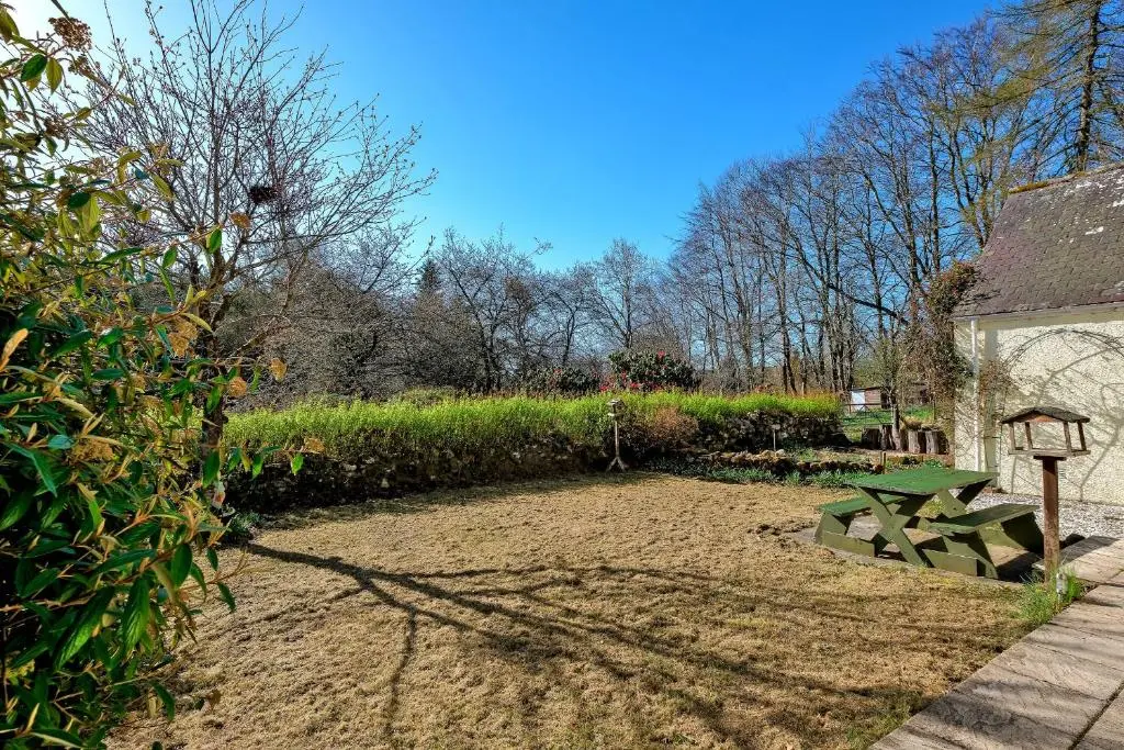 a picnic table in the middle of a garden at Finest Retreats - Corrennie School Cottage in Inverurie