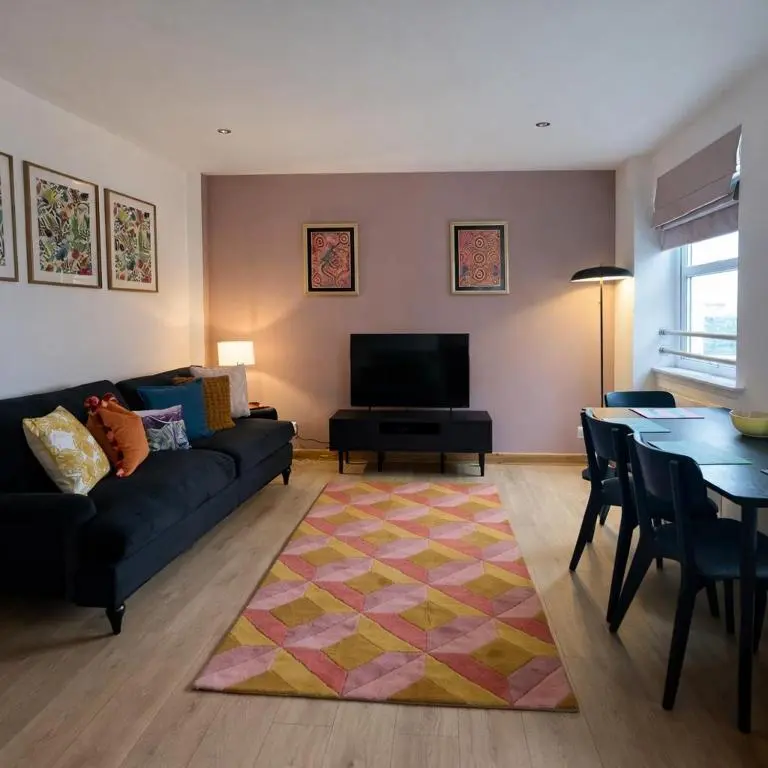 a living room with a couch and a table at The Inver Nest in Inverness
