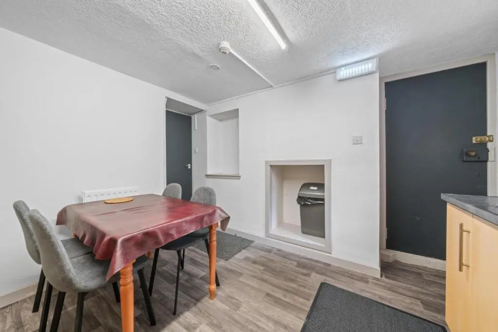 a kitchen and dining room with a table and chairs at Haugh 4 Bedroom House - Inverness in Inverness