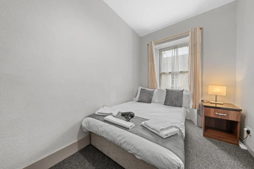 a bedroom with a bed with a dog on it at Haugh 4 Bedroom House - Inverness in Inverness