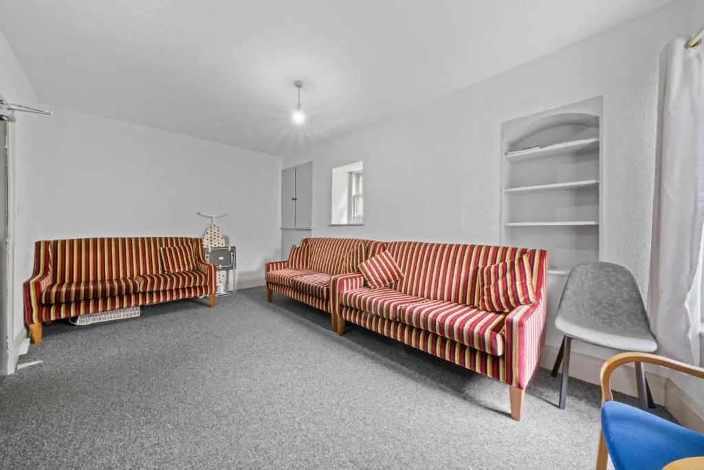 a living room with two couches and a table at Haugh 4 Bedroom House - Inverness in Inverness