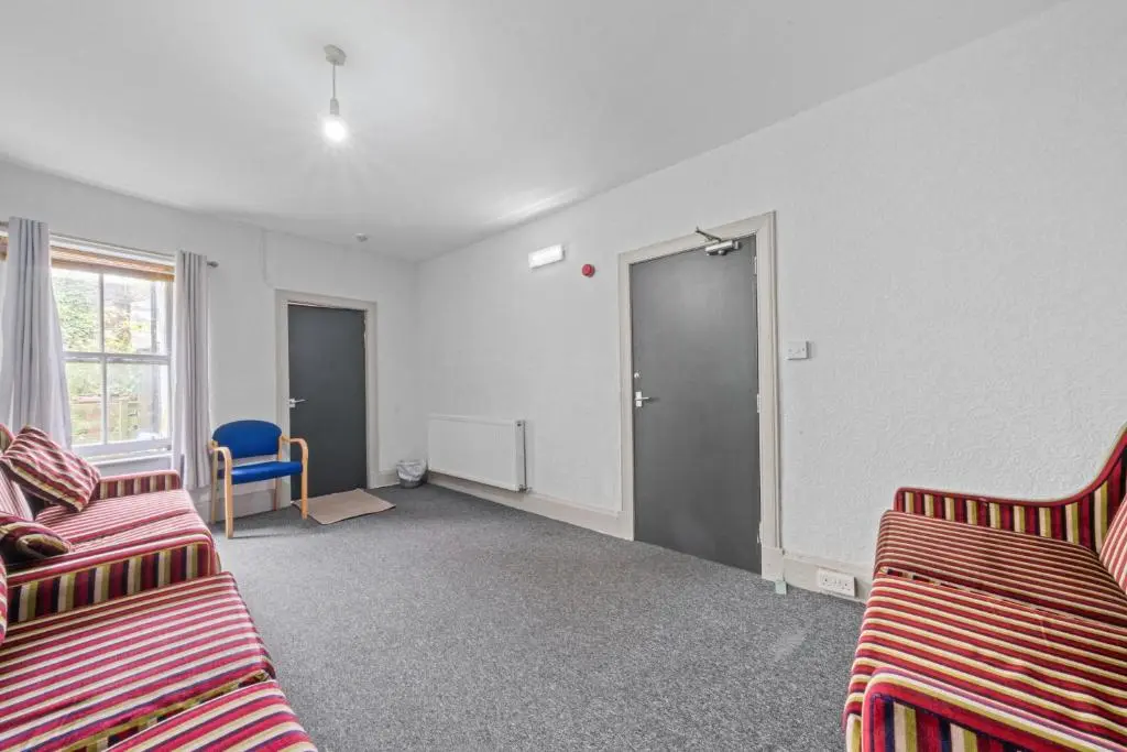 a living room with two beds and a door at Haugh 4 Bedroom House - Inverness in Inverness