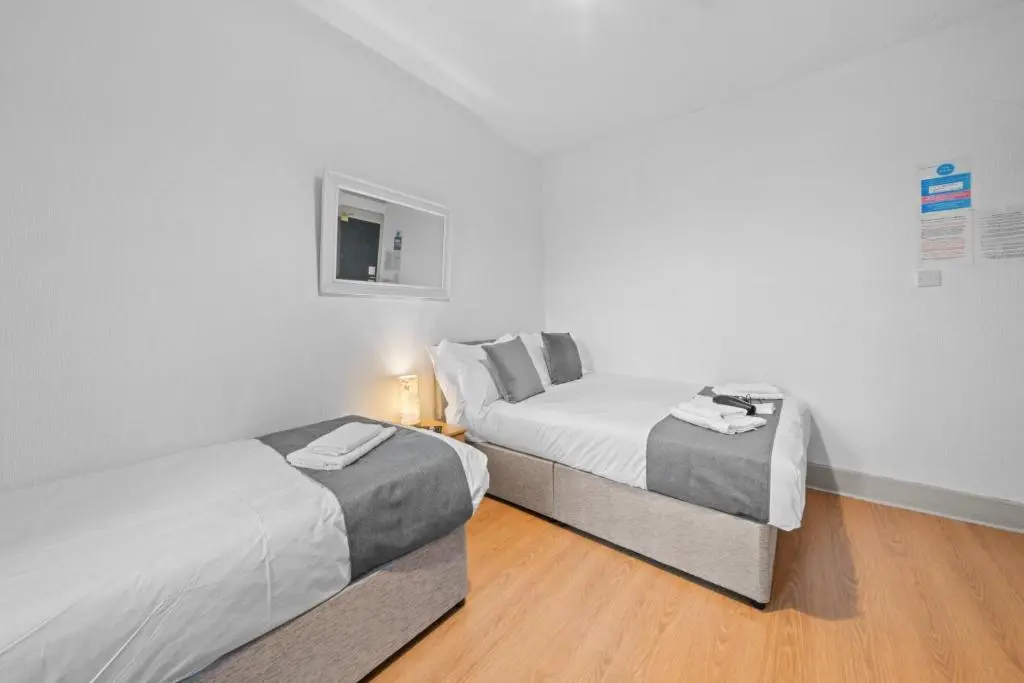 a bedroom with two beds and a window in it at 2 Bedroom Inverness Apartment - Perfect Location in Inverness