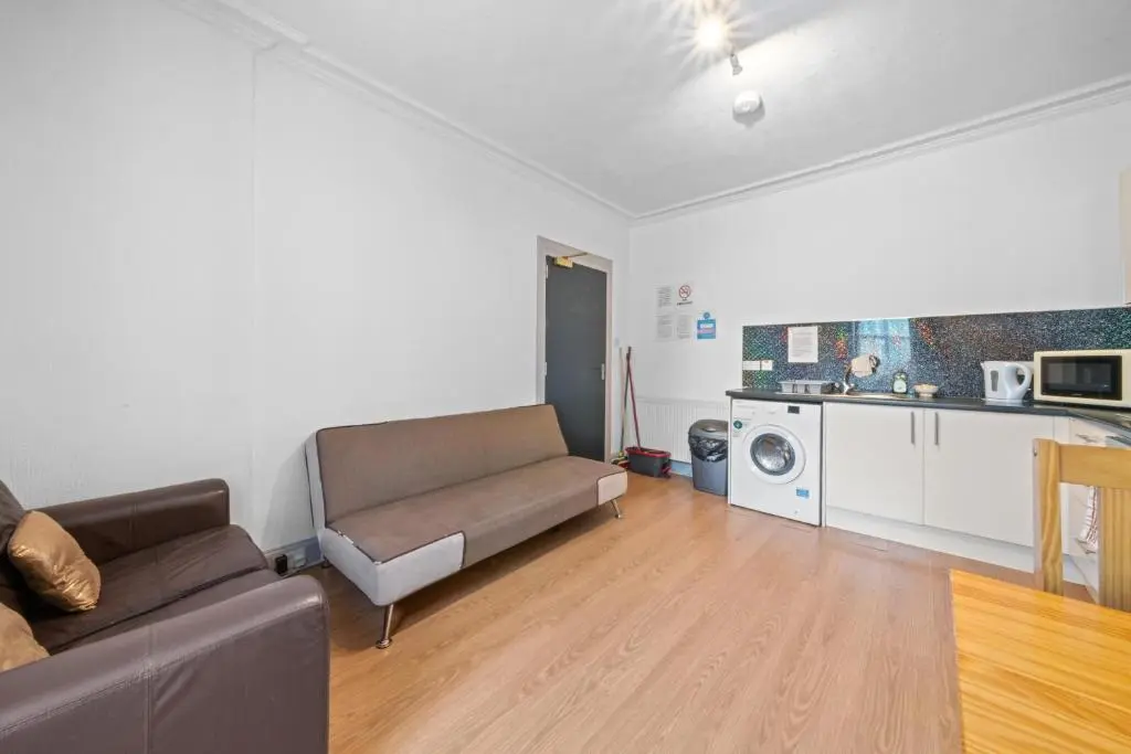 a living room with a couch and a kitchen at 2 Bedroom Inverness Apartment - Perfect Location in Inverness