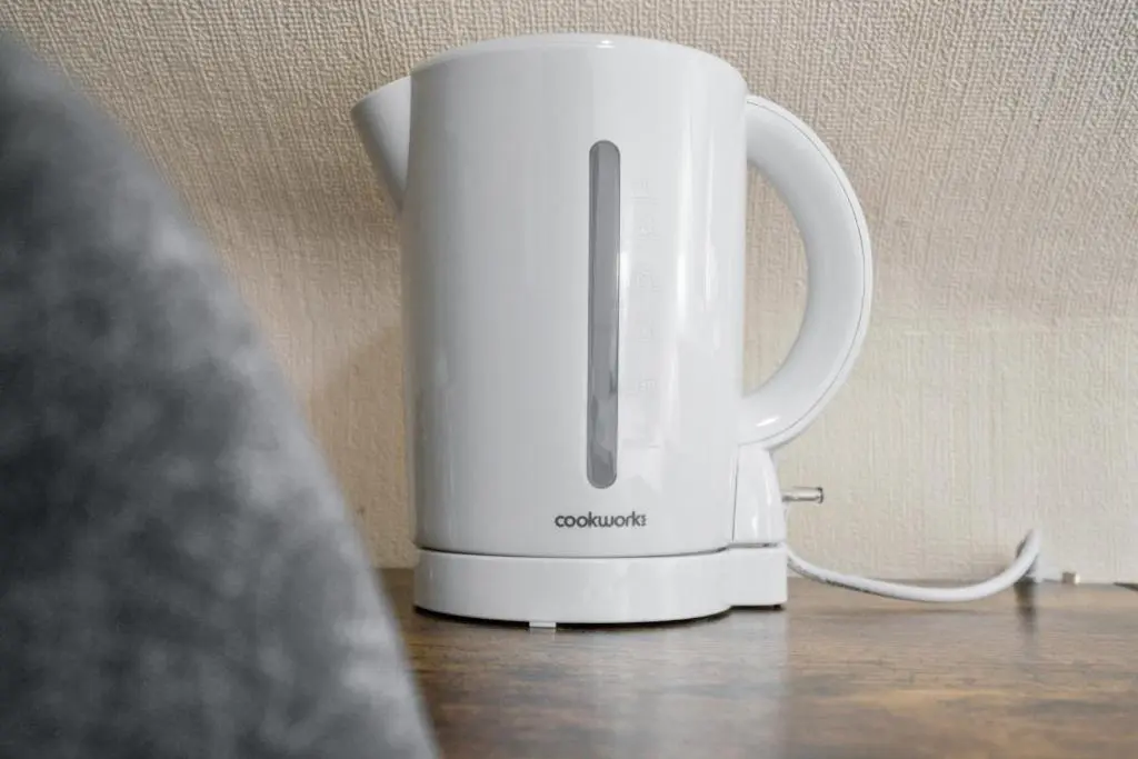 a white coffee pot sitting on a table at Struy Guest House - Inverness in Inverness