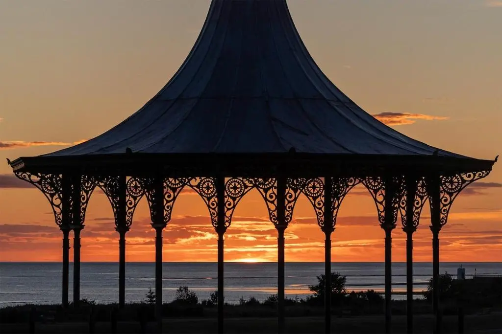 a gazebo at the beach at sunset at River views 5 mins from beach in Nairn