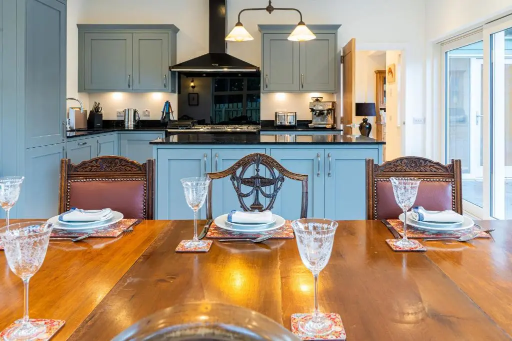 a kitchen with a wooden table with glasses on it at Old Coach House in Braemar