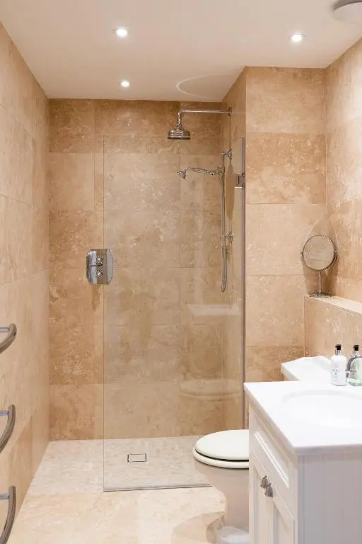 a bathroom with a shower and a toilet and a sink at Old Coach House in Braemar
