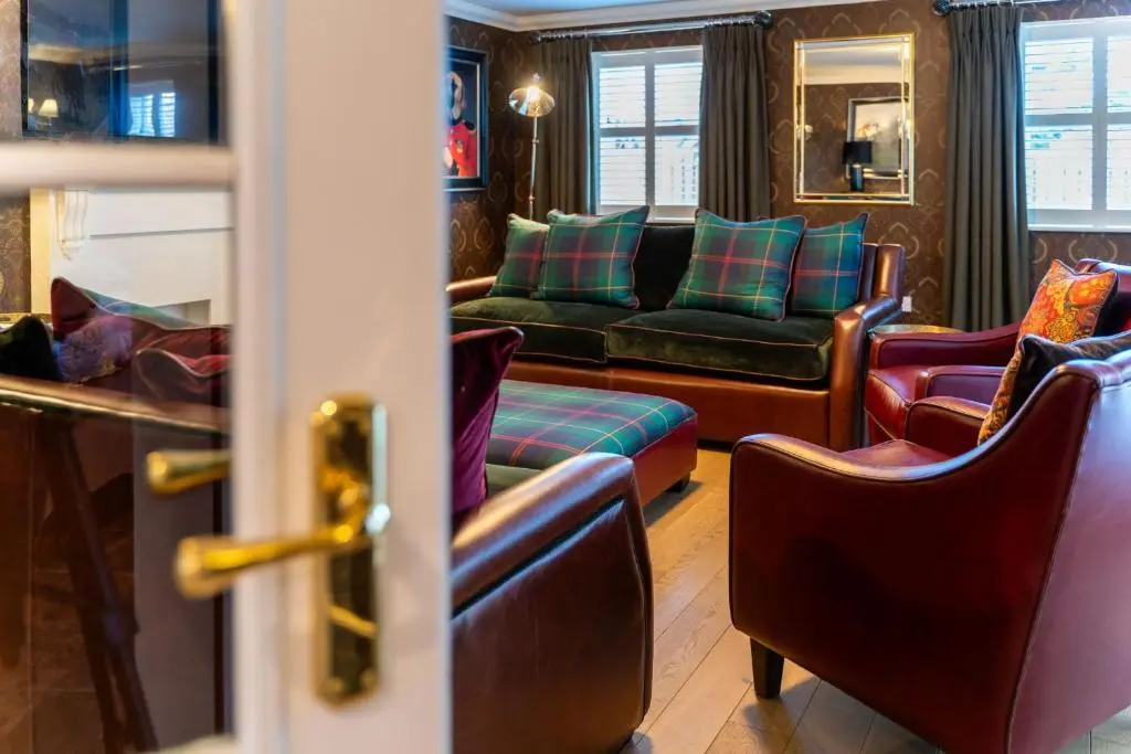 a living room with a couch and chairs at The Hayloft in Braemar