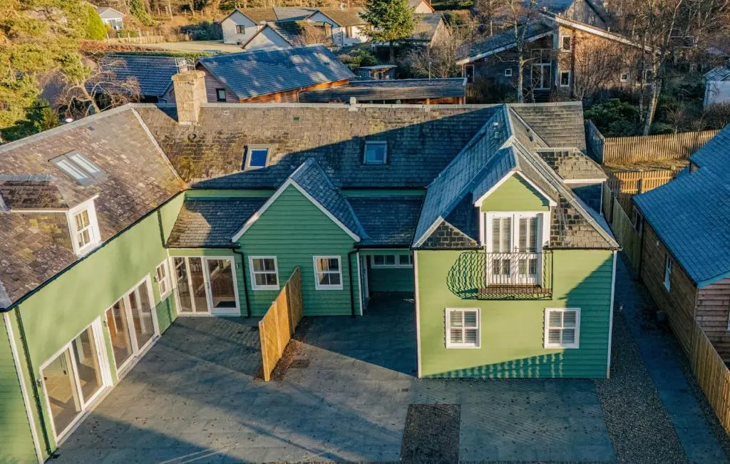 an overhead view of a house with green at The Old Coach House & The Hayloft in Braemar