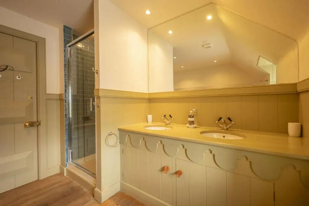 a bathroom with a sink and a mirror at Drum Cottage in Nethy Bridge