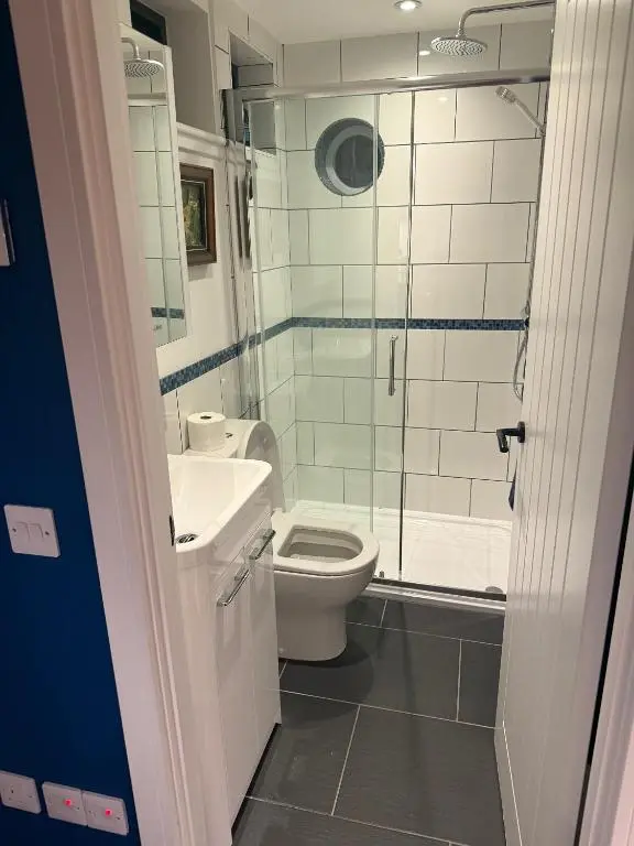 a bathroom with a toilet and a sink and a shower at The Boathouse at Croft Downie in Archiestown