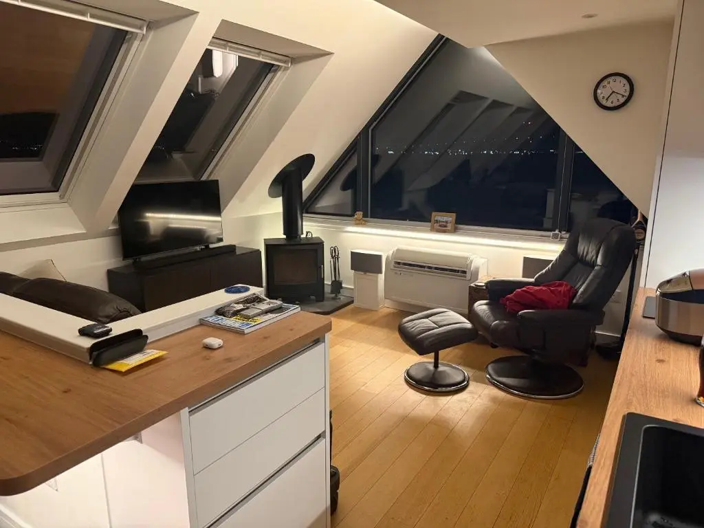 a living room with two chairs and a table at The Boathouse at Croft Downie in Archiestown