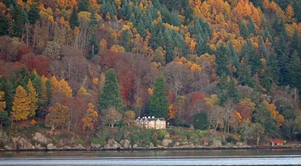 a house on an island in the middle of a lake at The Boathouse at Croft Downie in Archiestown
