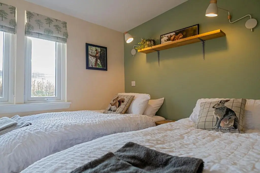 a bedroom with two beds and a window at The Drey Inchberry