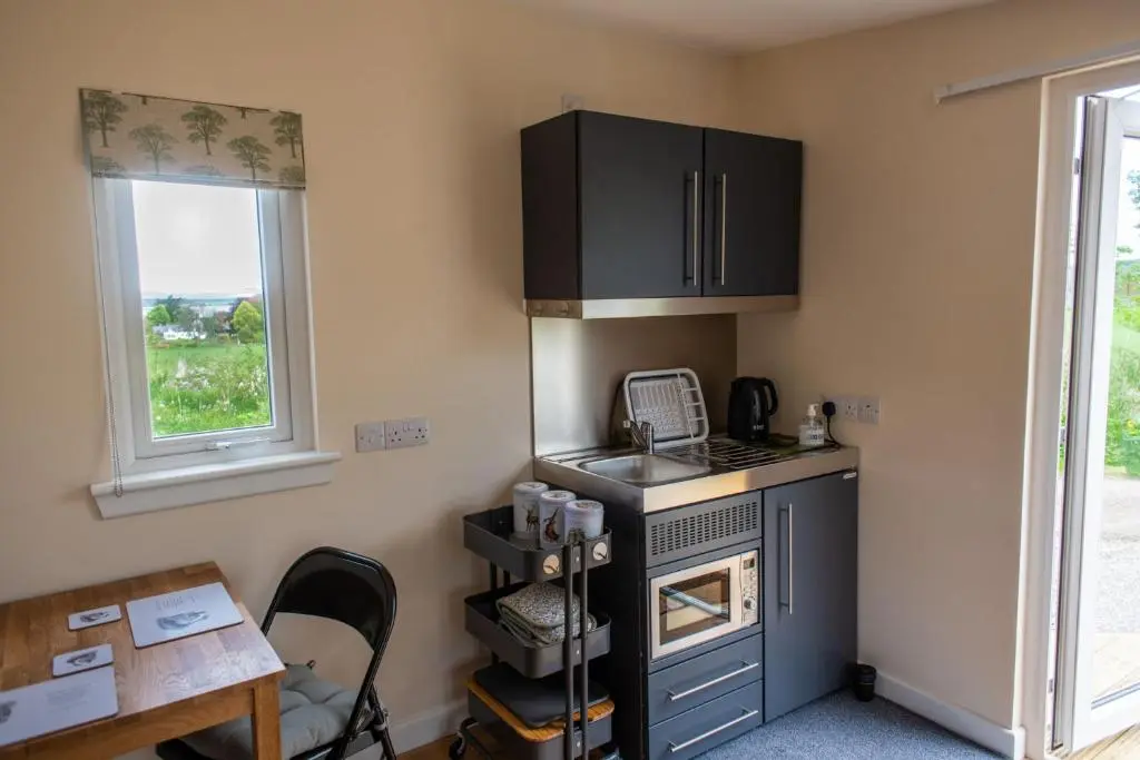a small kitchen with a stove and a window at The Drey Inchberry