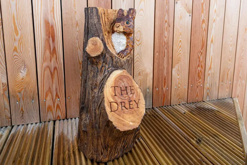 a piece of wood with a bear carved into it at The Drey Inchberry