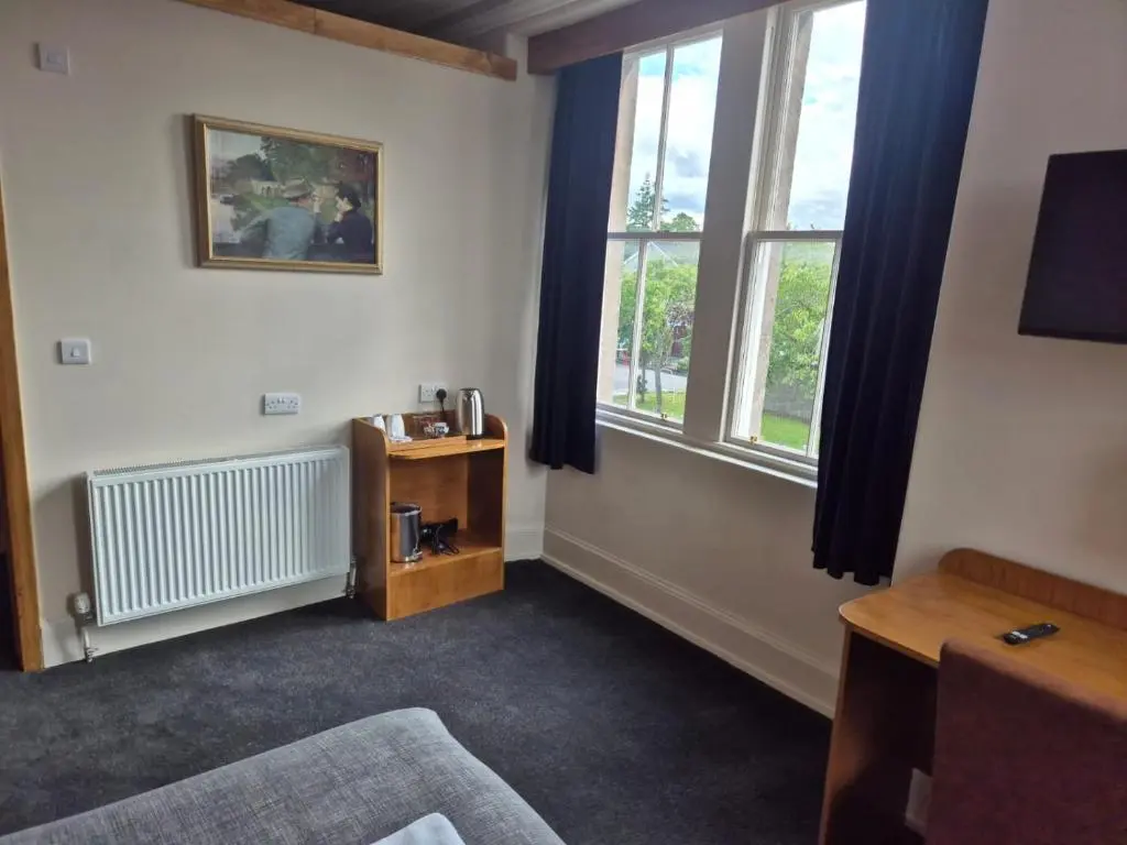 a room with a bed and a window at Bank House in Inverness
