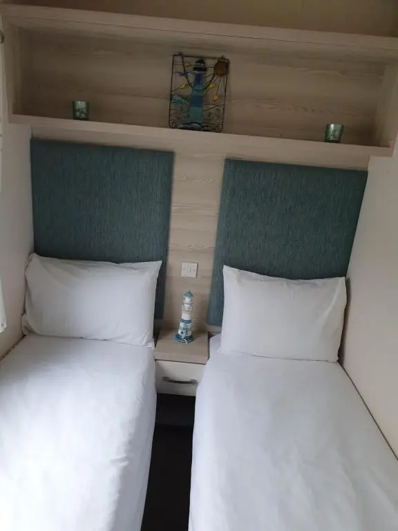 two beds sitting next to each other in a room at H26atsilversands in Lossiemouth