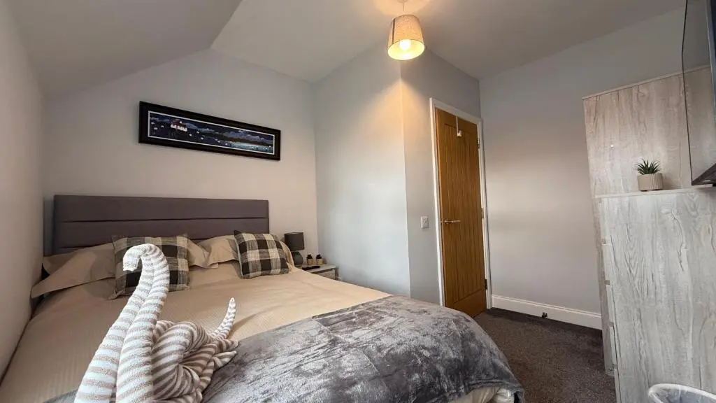 a bedroom with a large bed in a room at The Bakehouse - by Caithness Luxury Apartments NC500 - 5 Bedroom Luxury Holiday Home - Sleeps Work teams upto 5 & holiday makers upto 10 in Wick