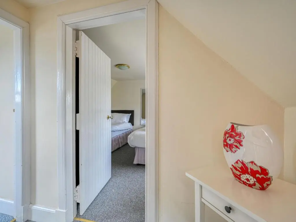 a hallway leading to a bedroom with a bed at Holiday Home The Manor House by Interhome in Balnain