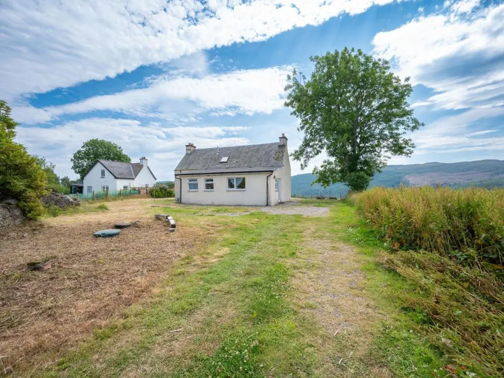 a white house in the middle of a field at Holiday Home The Manor House by Interhome in Balnain