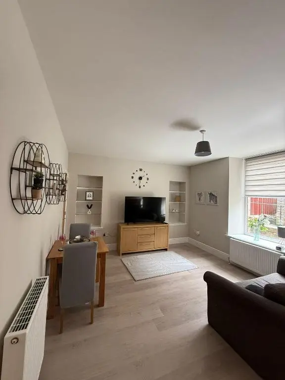 a living room with a table and a television at The Willows in Nairn