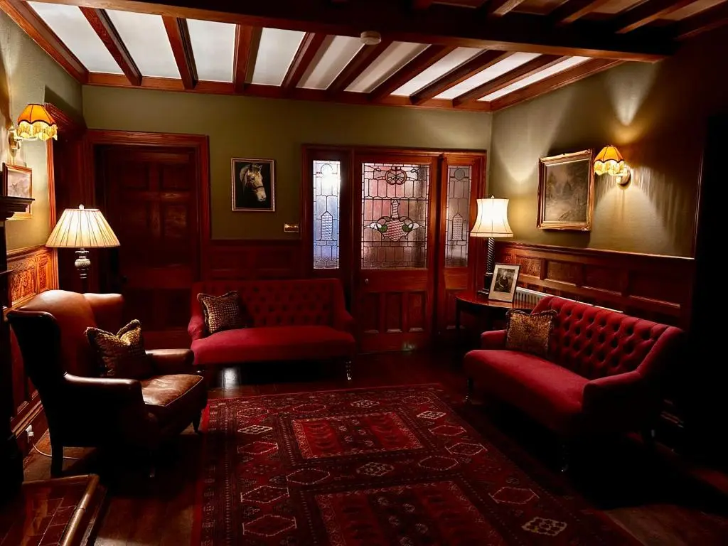 a living room with couches and chairs and a table at Clashmore House in Dornoch