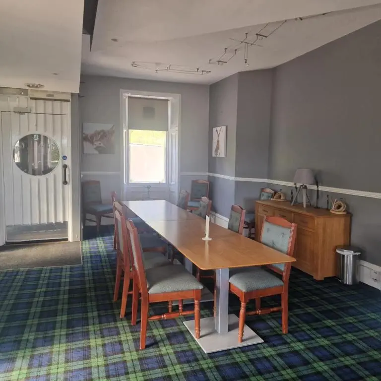 a dining room with a table and chairs at Black Isle Holiday Apartments Avoch in Avoch