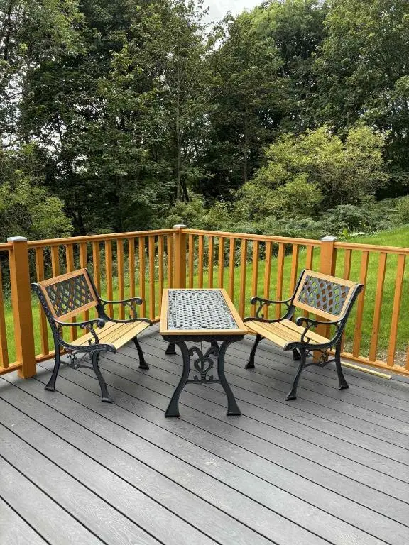 two benches and a table on a wooden deck at Shepherd's Bothy, Bothan a Bhuachaille, Black Isle in Munlochy