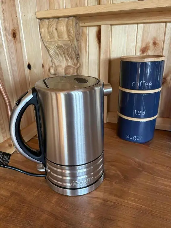 a silver coffee pot and a cup on a table at Shepherd's Bothy, Bothan a Bhuachaille, Black Isle in Munlochy