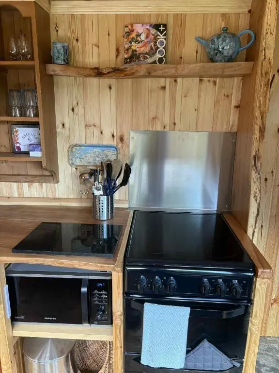 a kitchen with a stove and a stove top at Shepherd's Bothy, Bothan a Bhuachaille, Black Isle in Munlochy