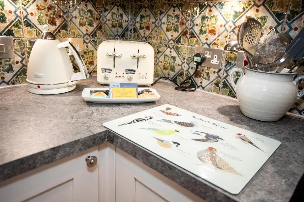 a kitchen counter with a toaster and a cutting board at Harris House in Inverness